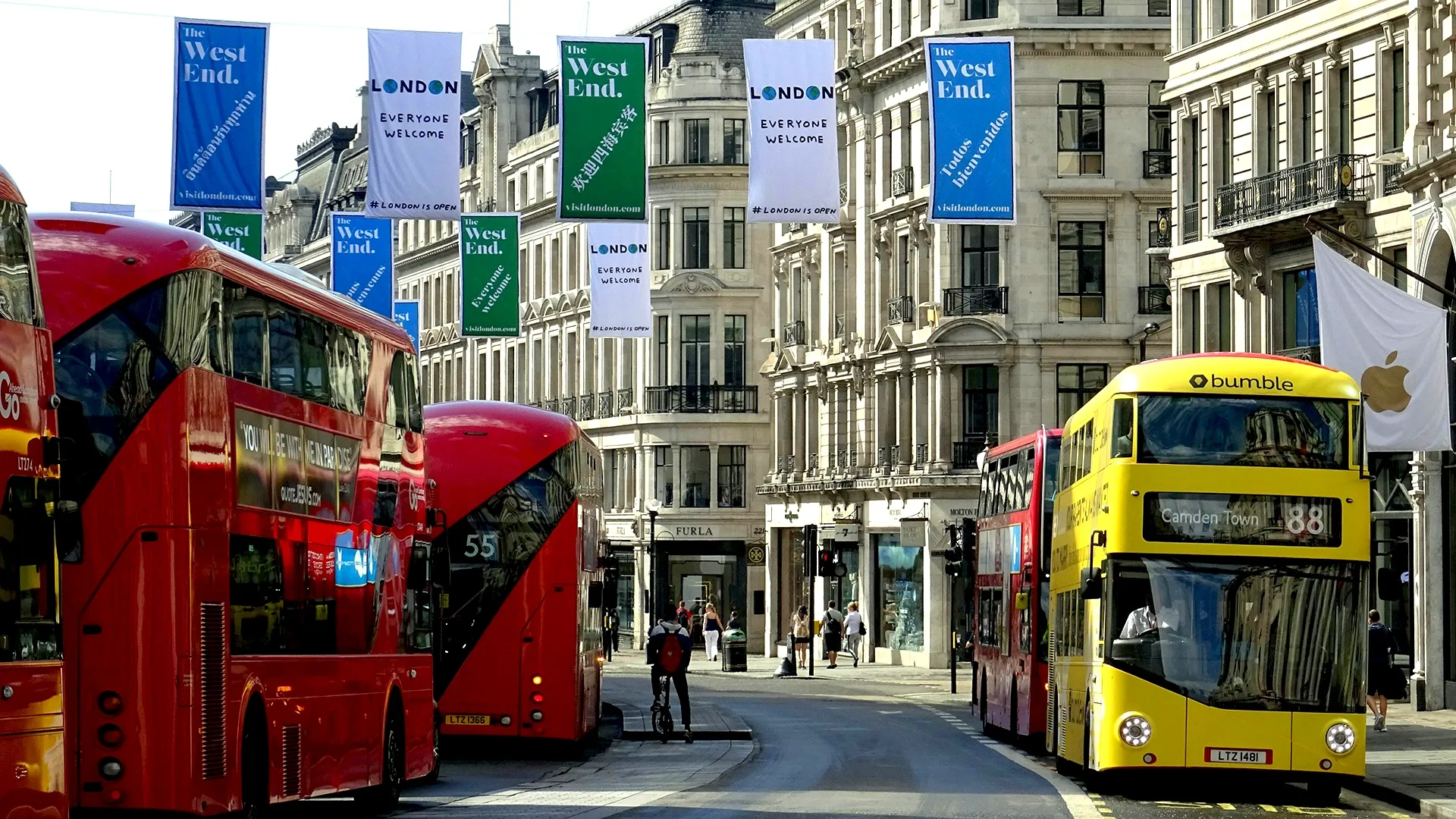 Brnaded red London buses travelling down Regent Street in London's West End