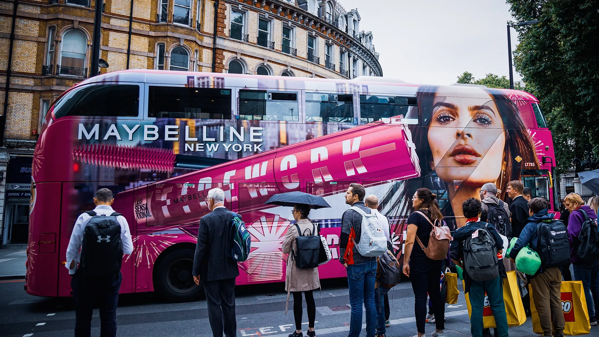 A Routemaster London bus wrapped in Maybelline Firework branding