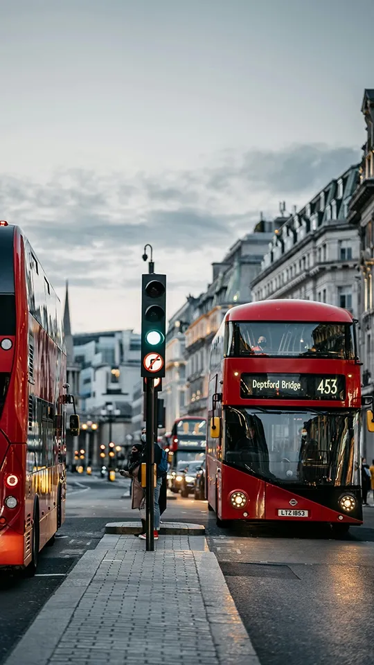 Two buses passing on a London street